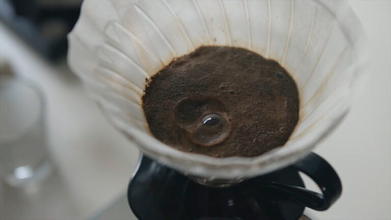 Close-up of freshly brewed coffee grounds in a drip coffee filter