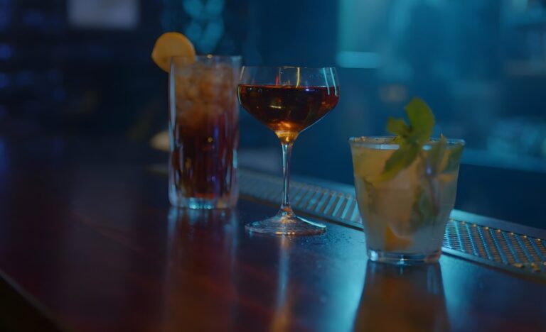 A trio of expertly crafted cocktails, sits ready on a polished bar top