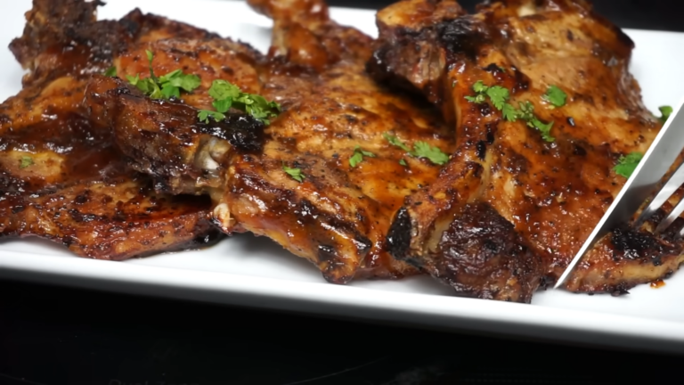 A Plate of Perfectly Cooked Pork Chops Garnished with Parsley, Showcasing the Ideal Cooking Time for Pork Chops at 350°F