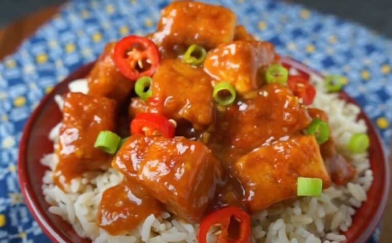 A close-up view of savory tofu, coated in a sweet and tangy sauce