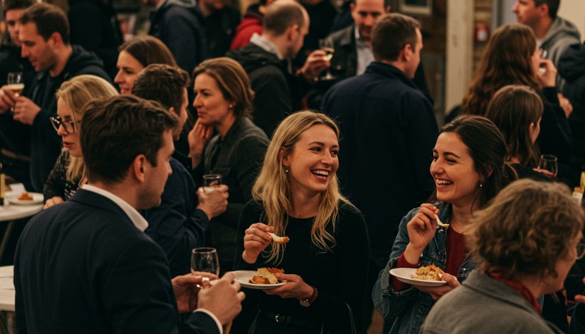 A lively gathering of professionals, enjoying conversation and refreshments
