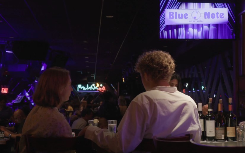 A dimly lit jazz club, hushed conversation, and the promise of live music