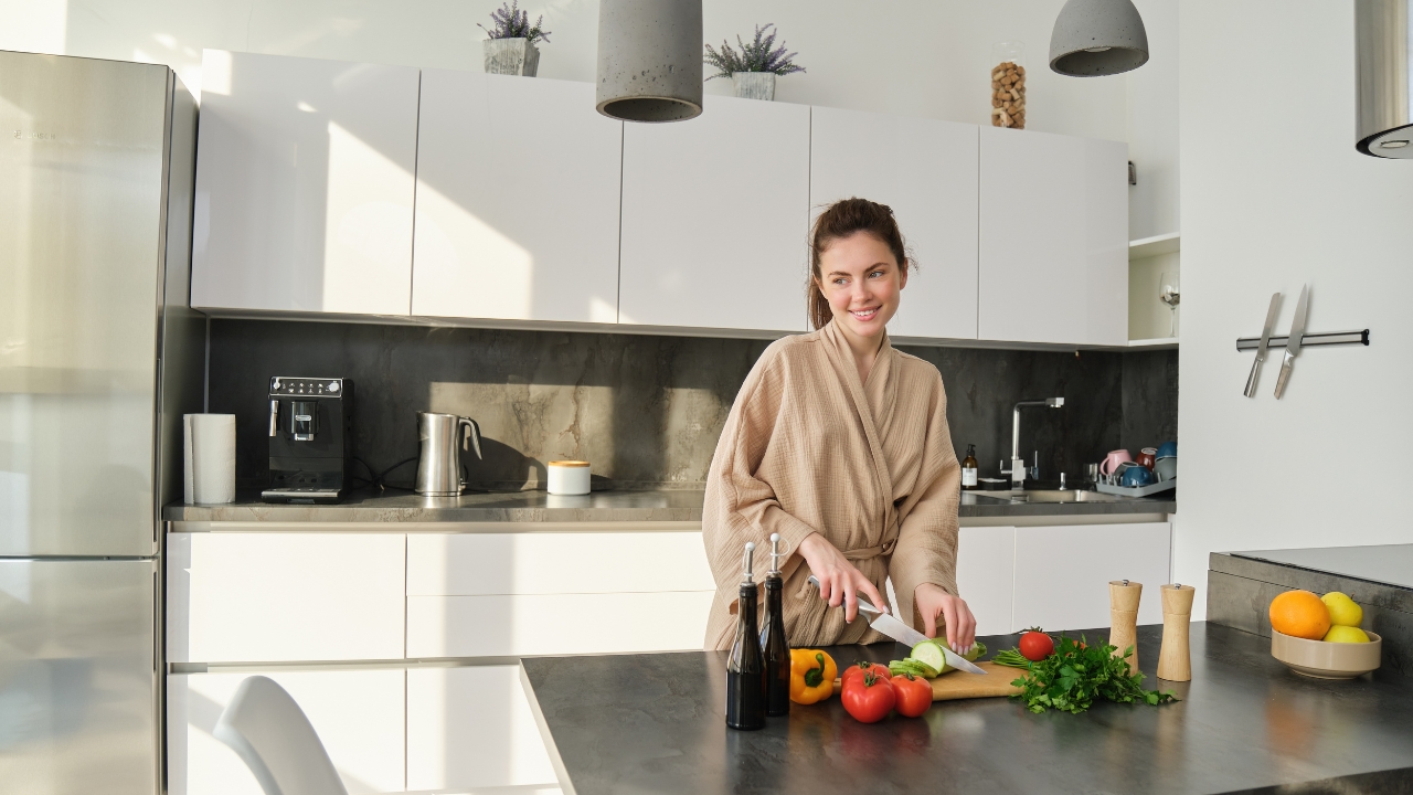 Kitchen upgrades in a modern kitchen as a woman prepares fresh vegetables on the counter
